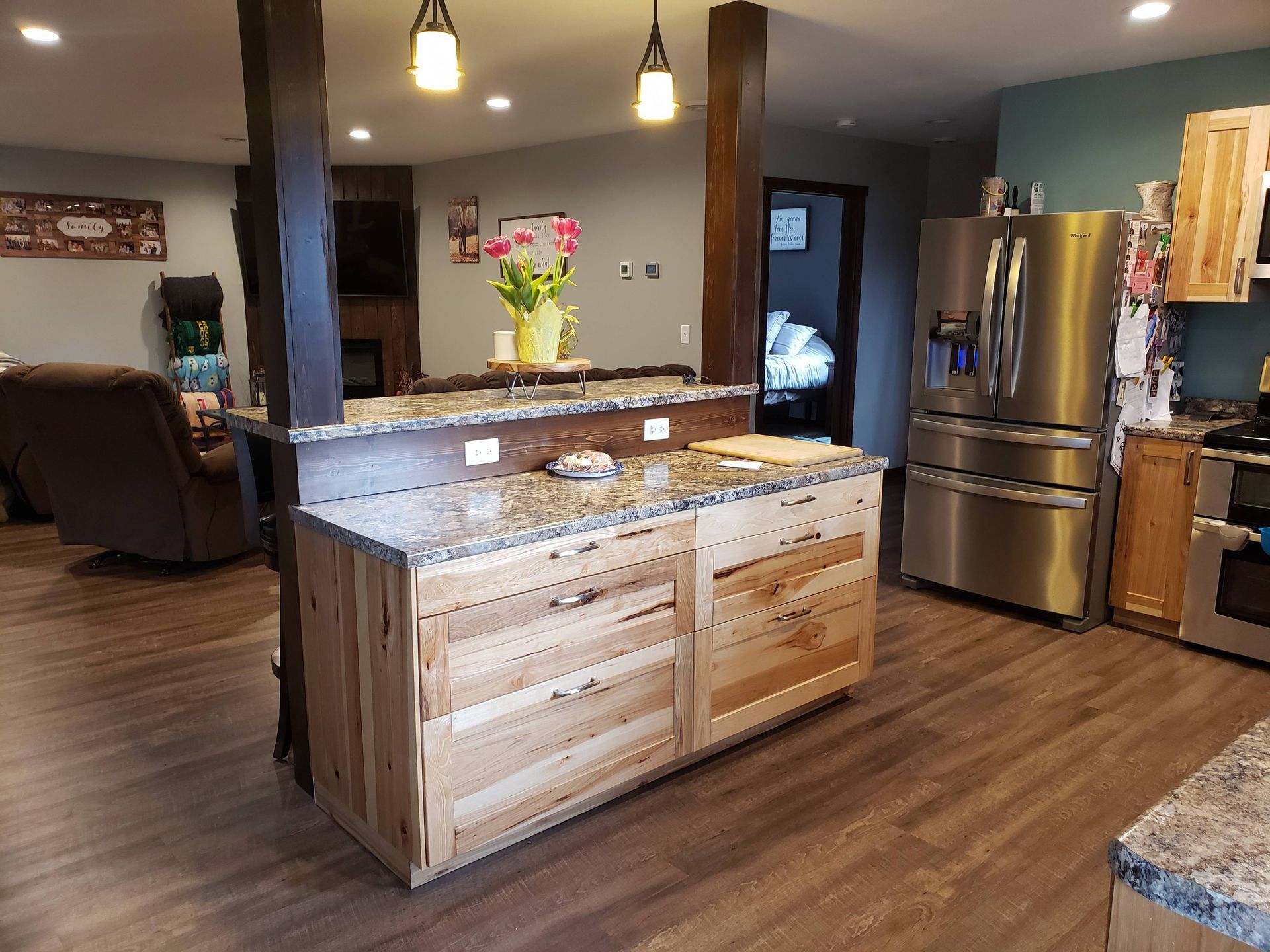 A kitchen with stainless steel appliances and wooden cabinets.