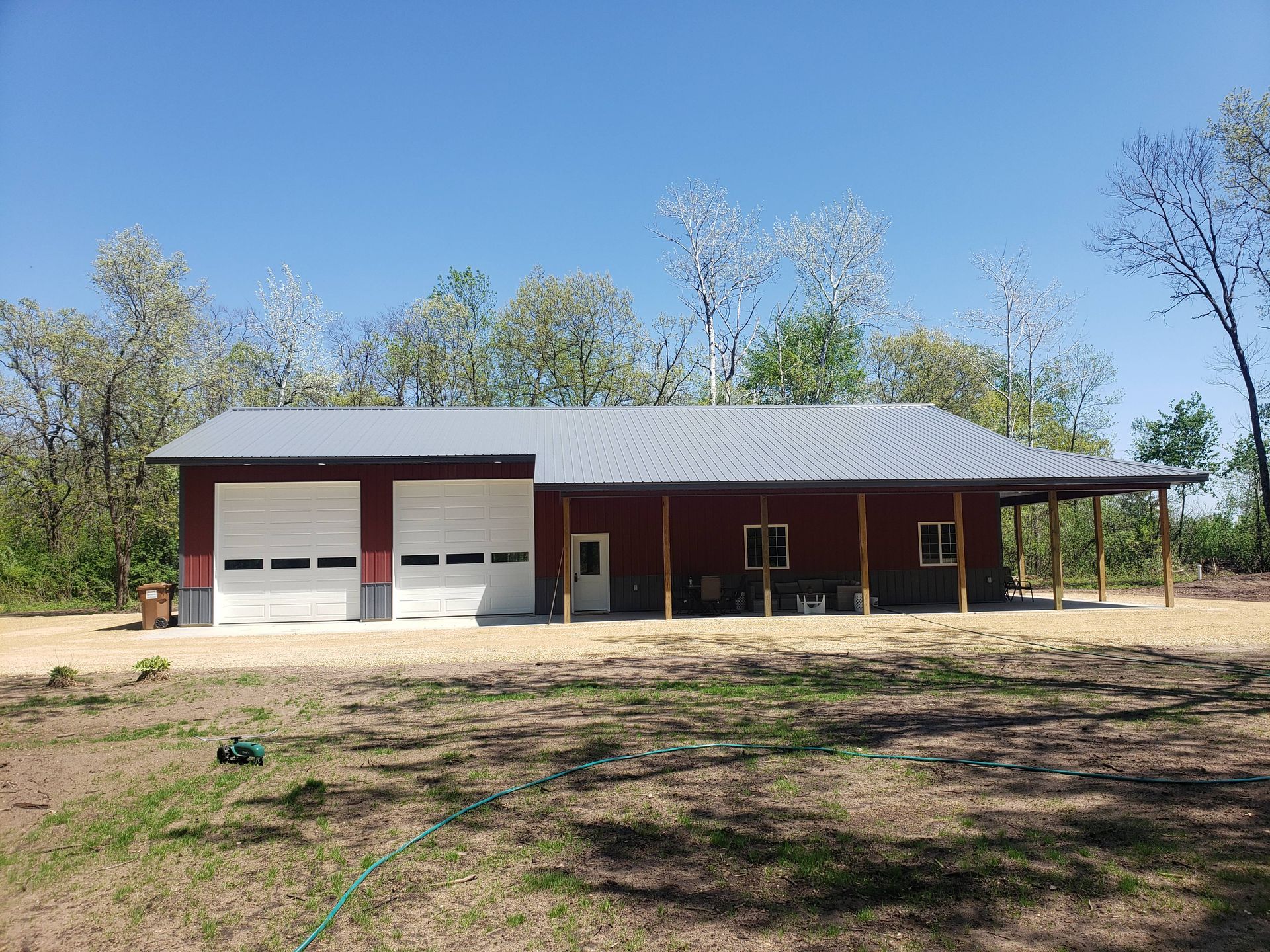 A large red house with a white garage door and a porch.