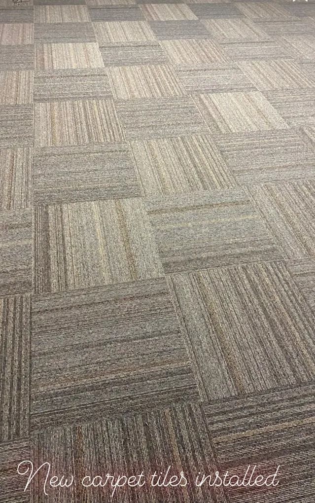 New gray patterned carpet tiles installed