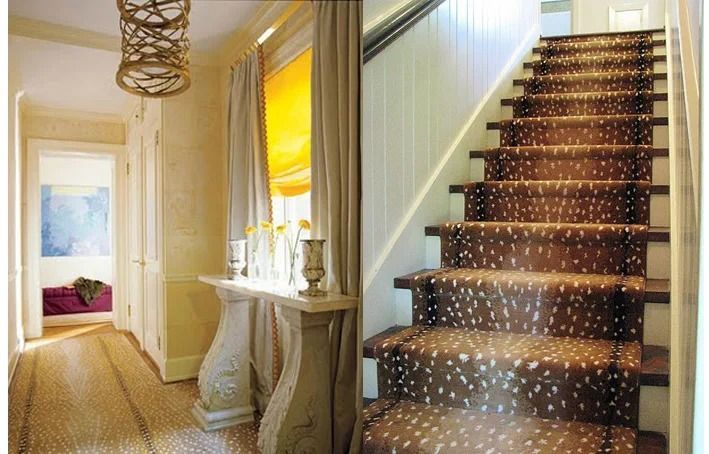 Elegant hallway with patterned staircase, console table, and bright doorway leading to a bedroom