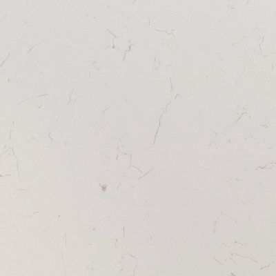 Close-up of a white wall with faint cracks and small marks