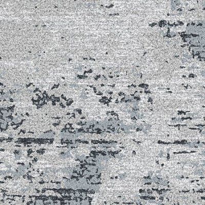 Close-up of weathered gray concrete with scattered dark patches and stains
