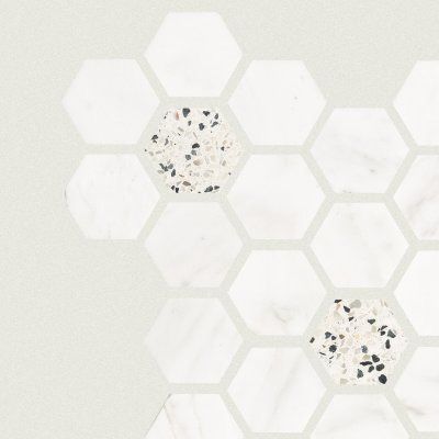 White hexagonal tile pattern on a light background with two speckled decorative hexagons