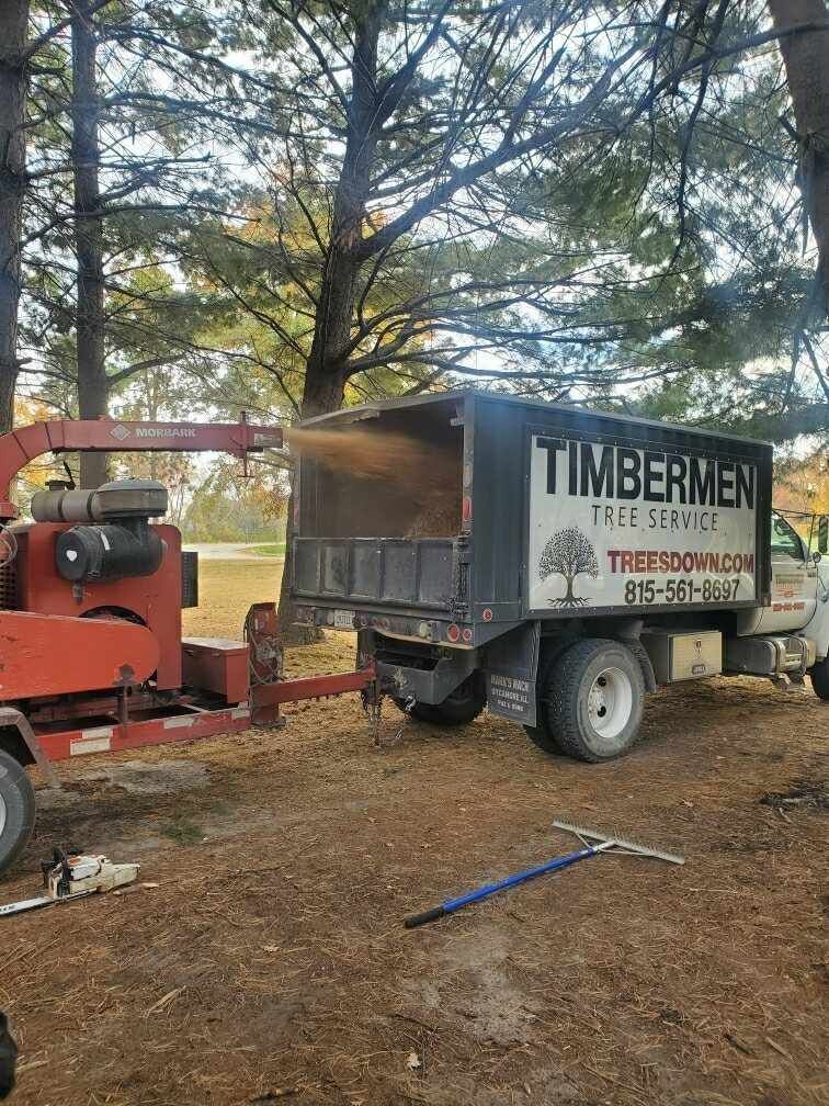 A truck with a tree chipper attached to it.