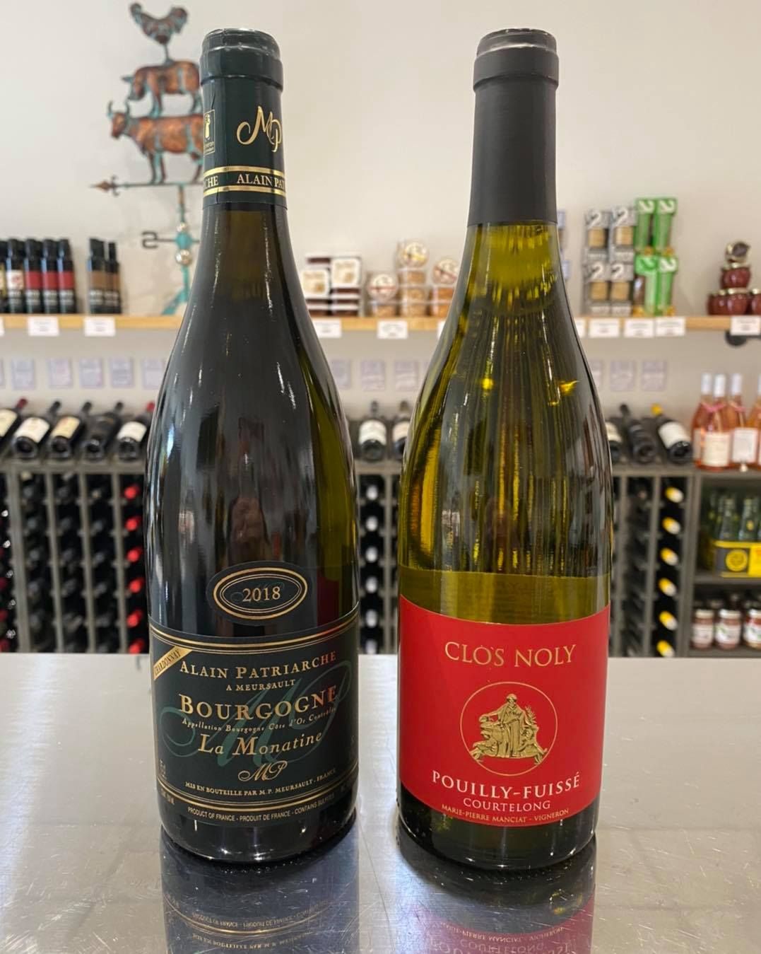 Two bottles of wine are sitting next to each other on a counter.