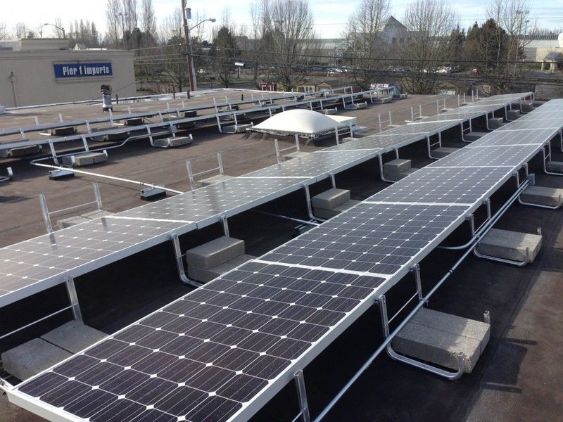 Solar panels on a flat commercial roof, with support structures and ventilation units.
