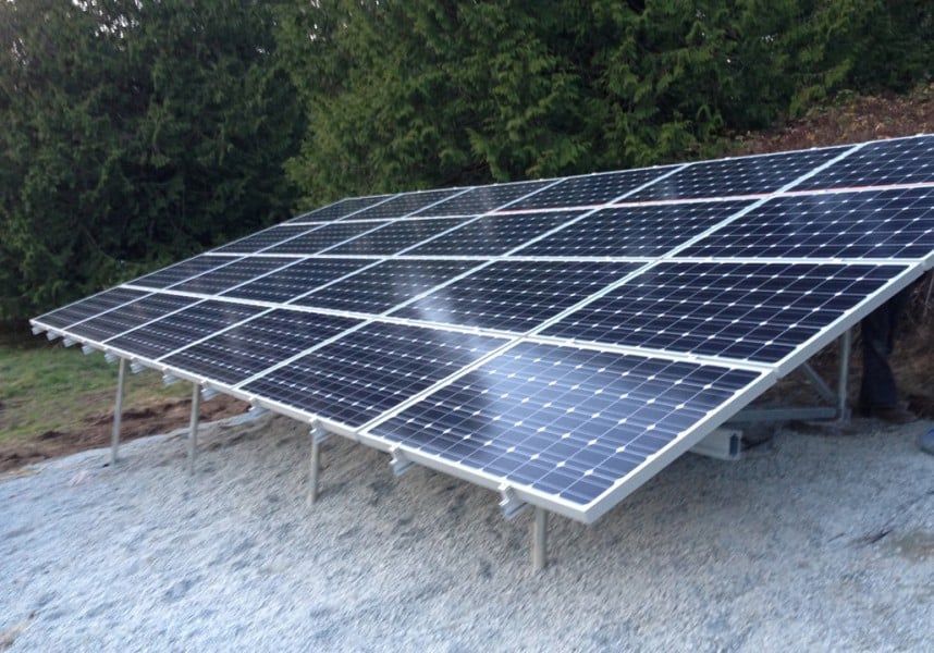 Solar panels installed on a hillside, capturing sunlight.