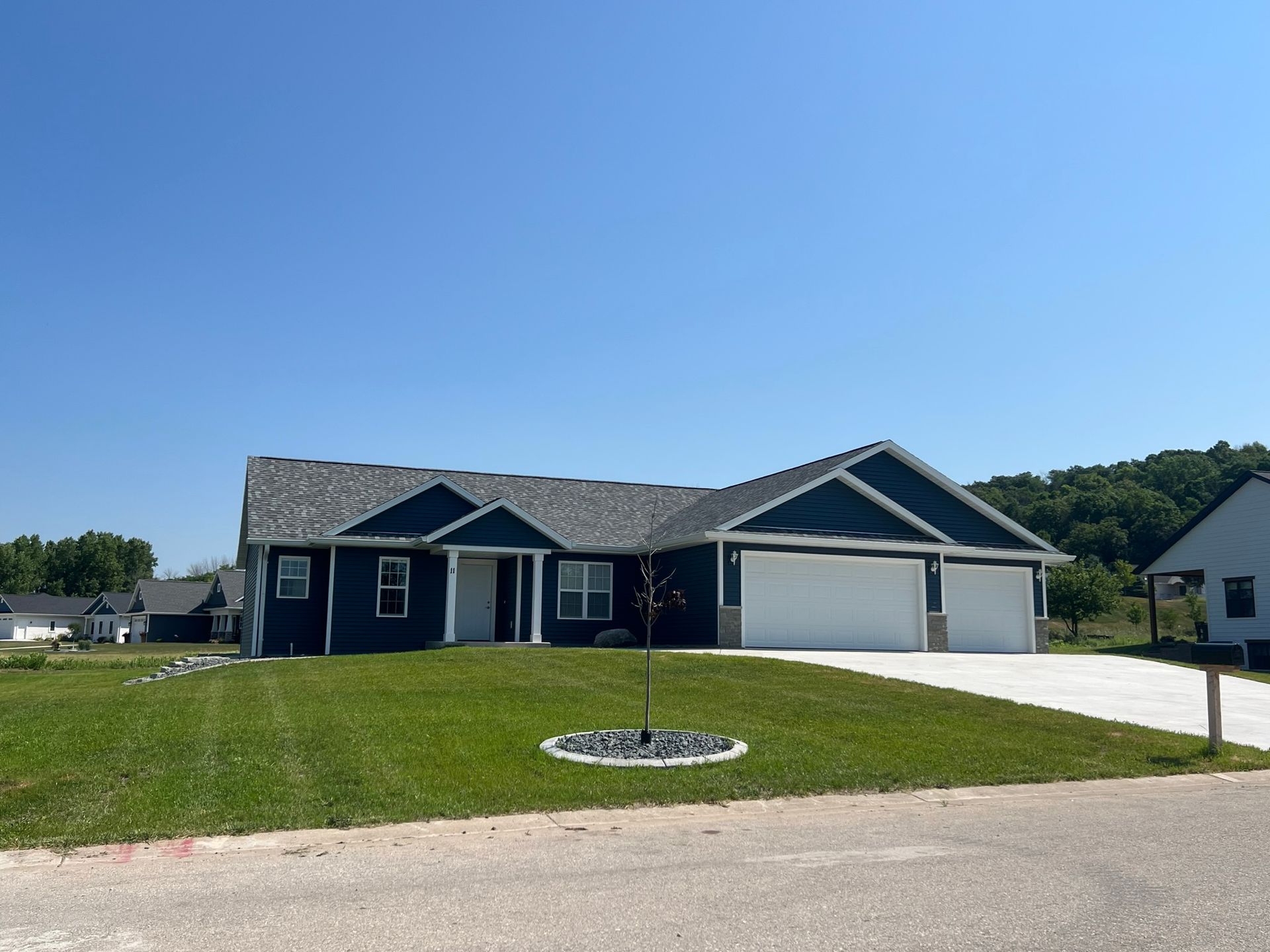 A house with a lush green lawn in front of it
