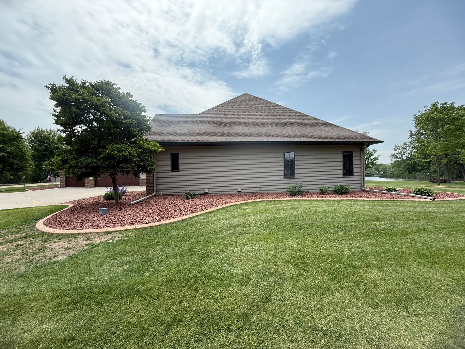 A house with a large lawn in front of it
