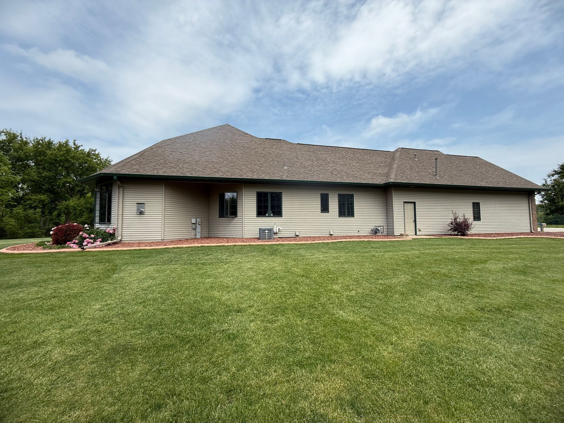A house with a large lawn in front of it