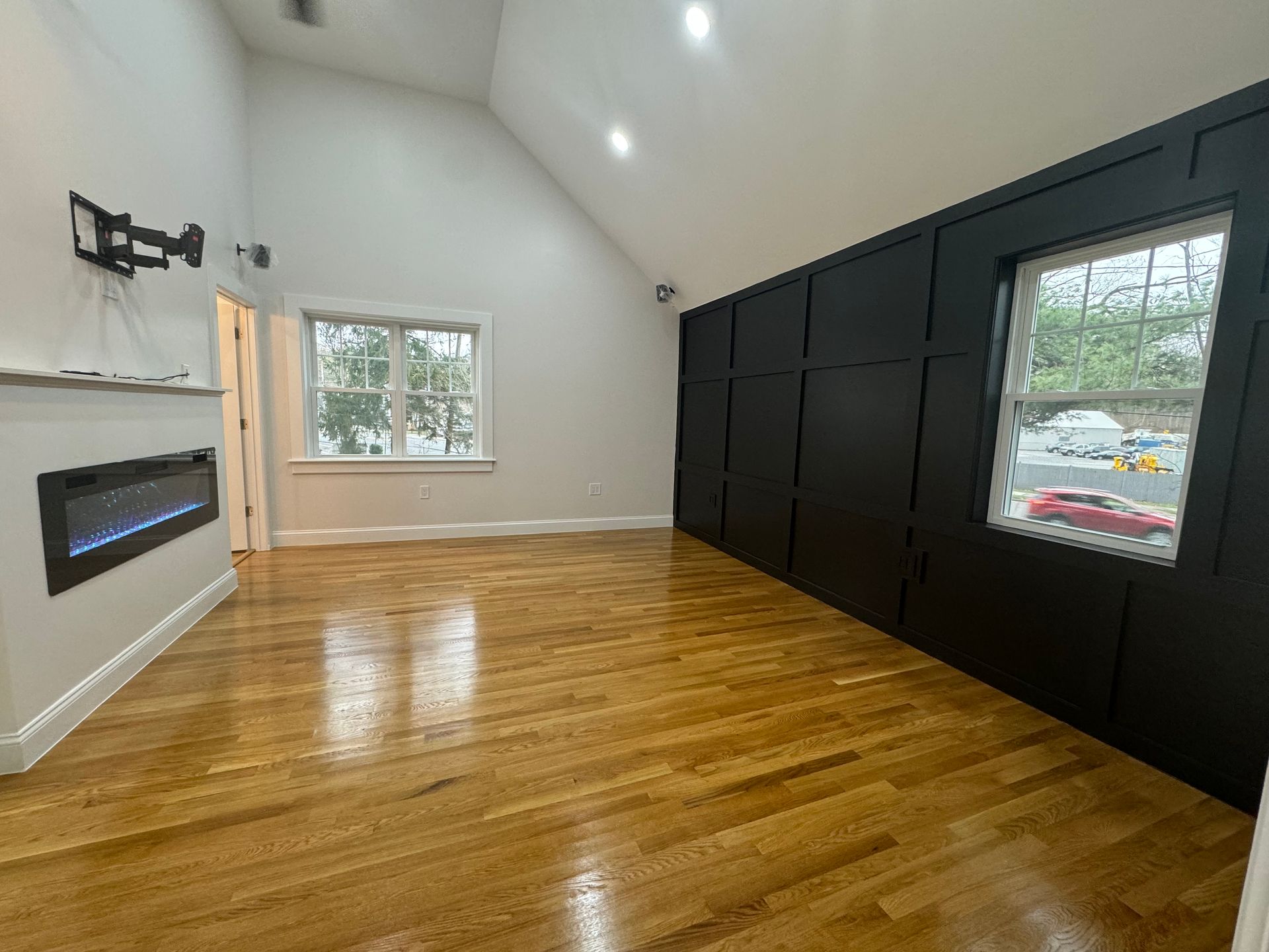 A couple of people are walking in front of a large white house.