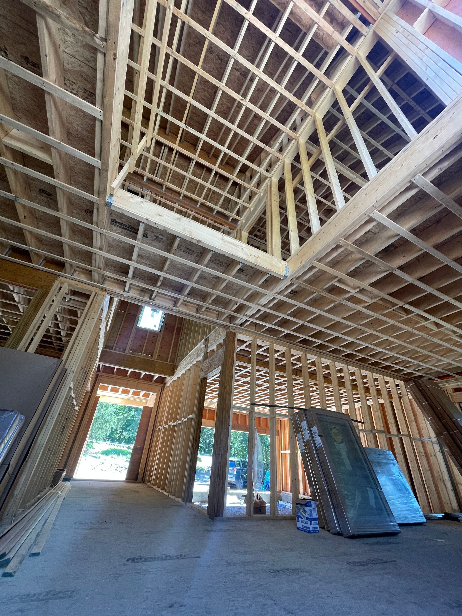 A blue and white house with a red car parked in front of it.