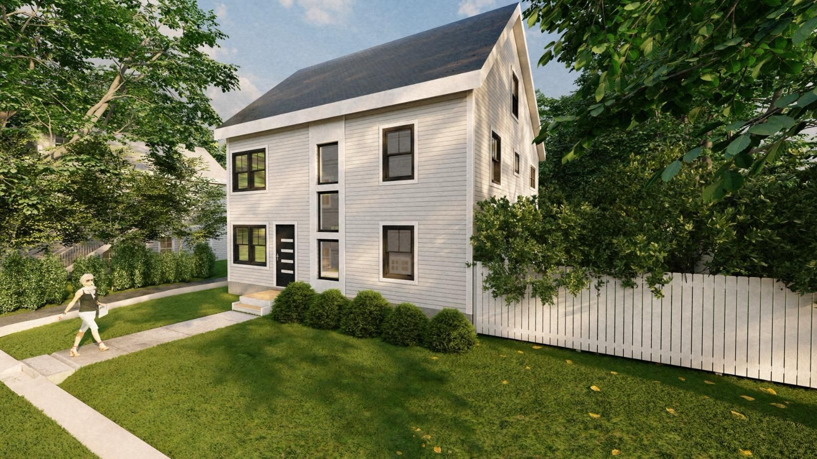 A man is walking in front of a large house at night.