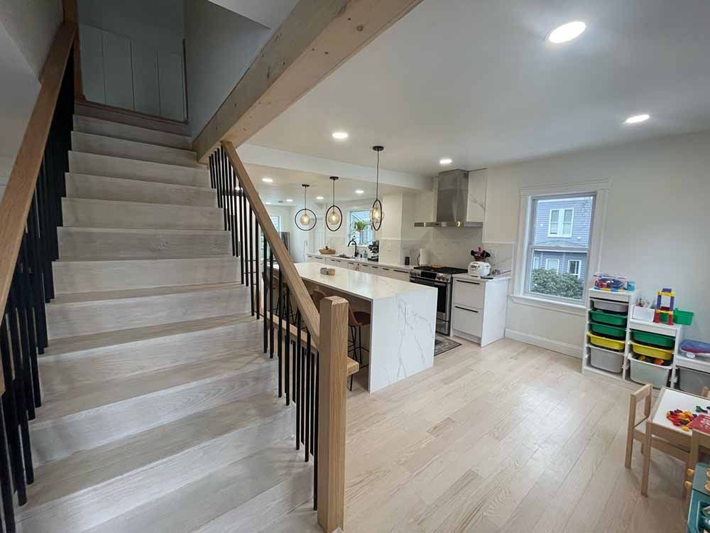 A kitchen with a staircase leading up to the second floor.
