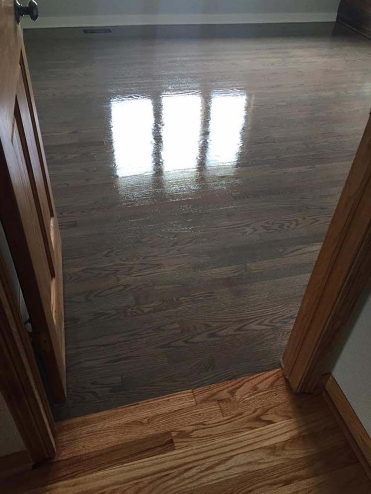 A room with hardwood floors and a doorway leading to it.