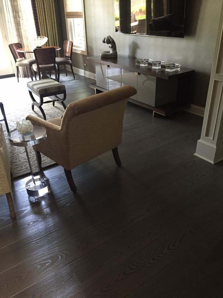 A living room with a couch , chair , table and television.