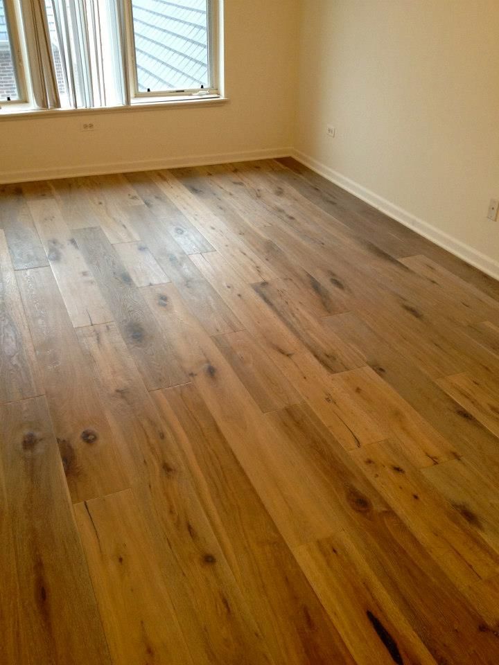 A room with hardwood floors and a window.
