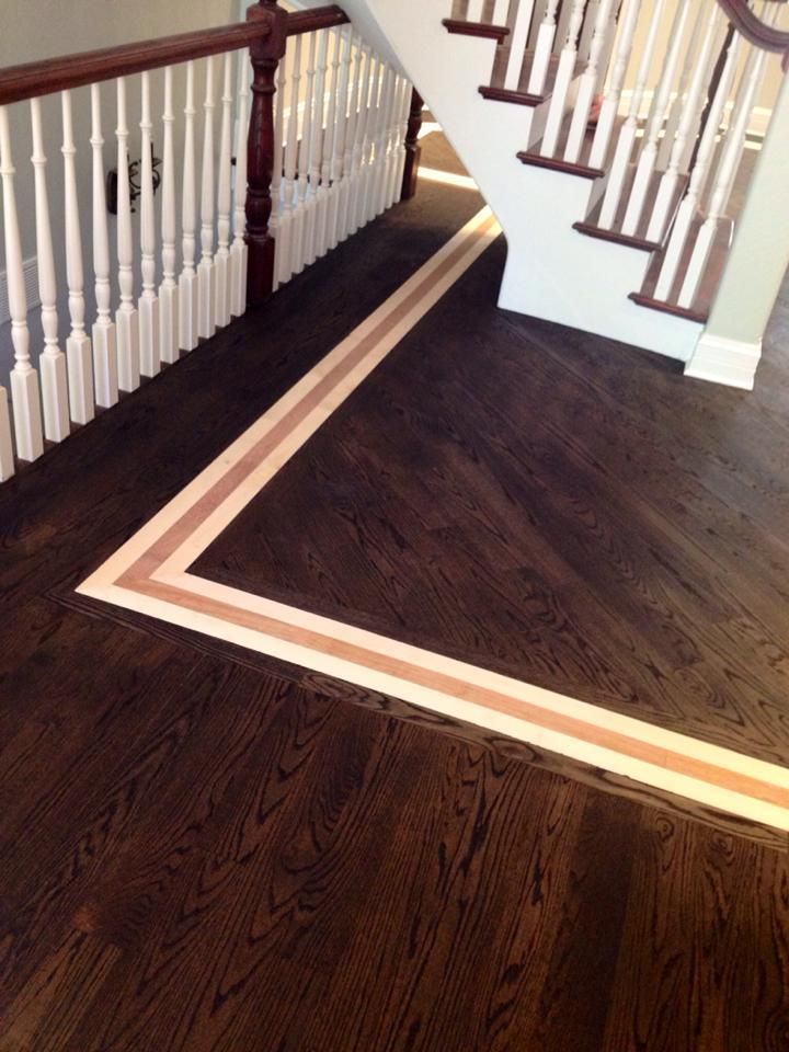 A staircase with a wooden floor and a white railing.