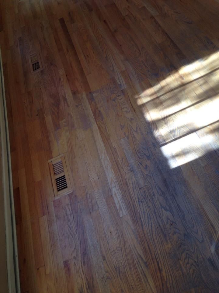 A close up of a wooden floor in a room with a window.