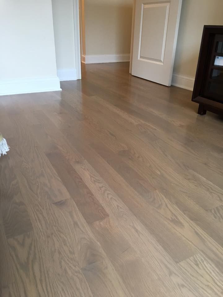 A living room with hardwood floors and a door.