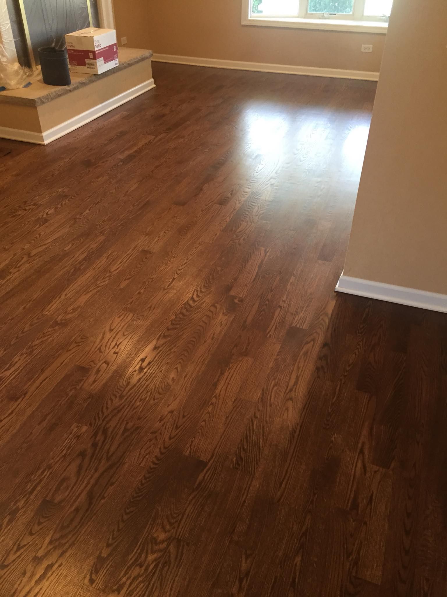 A living room with hardwood floors and a fireplace.