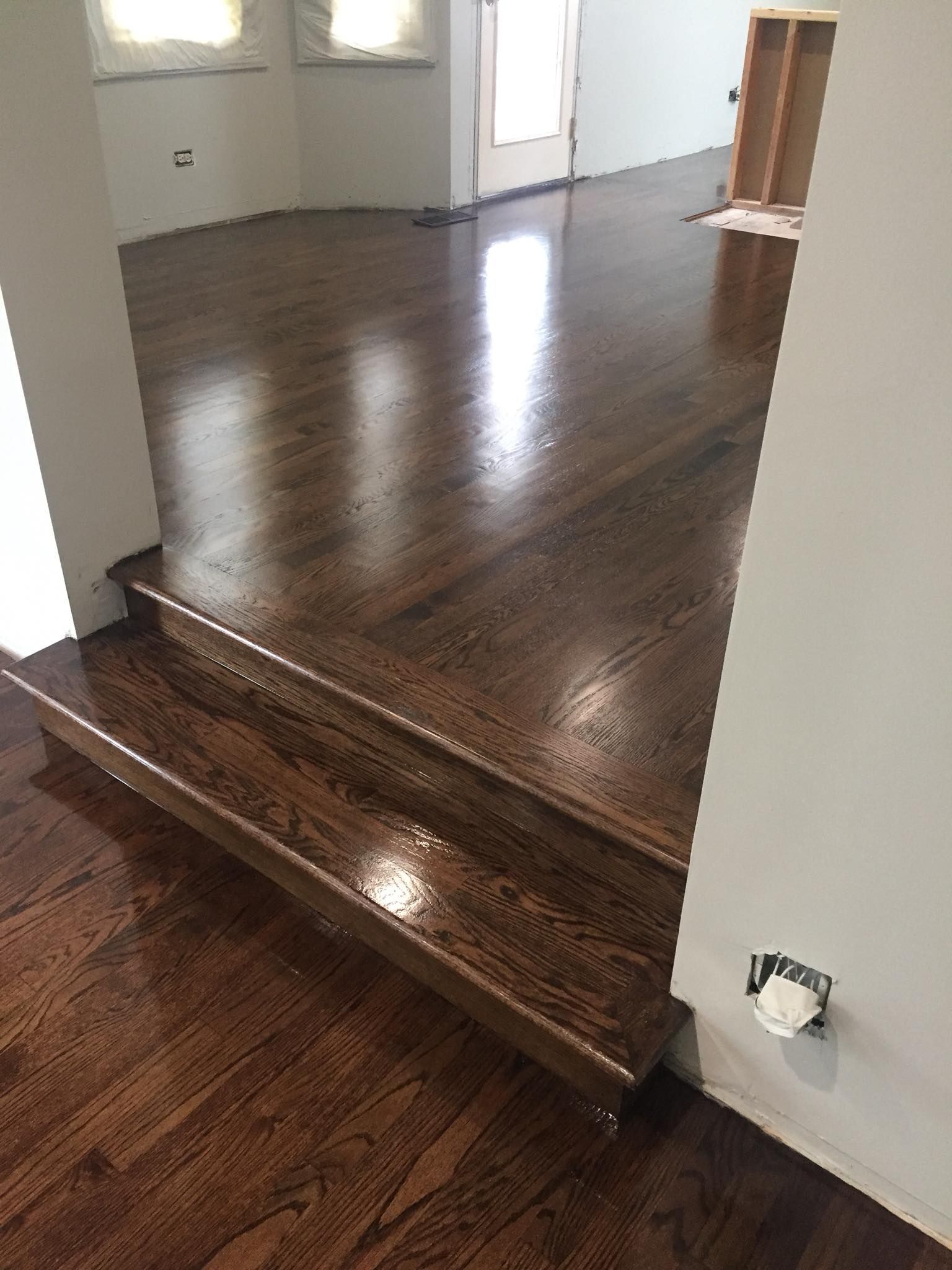 A room with hardwood floors and stairs in it.