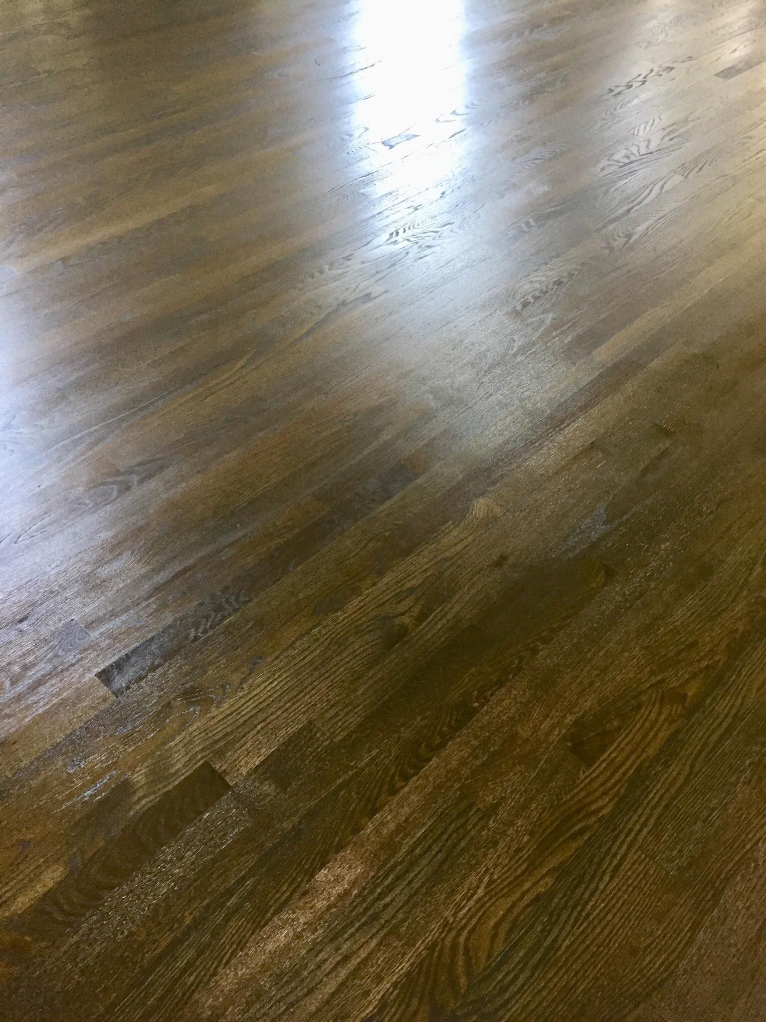 A close up of a wooden floor with a light shining on it.