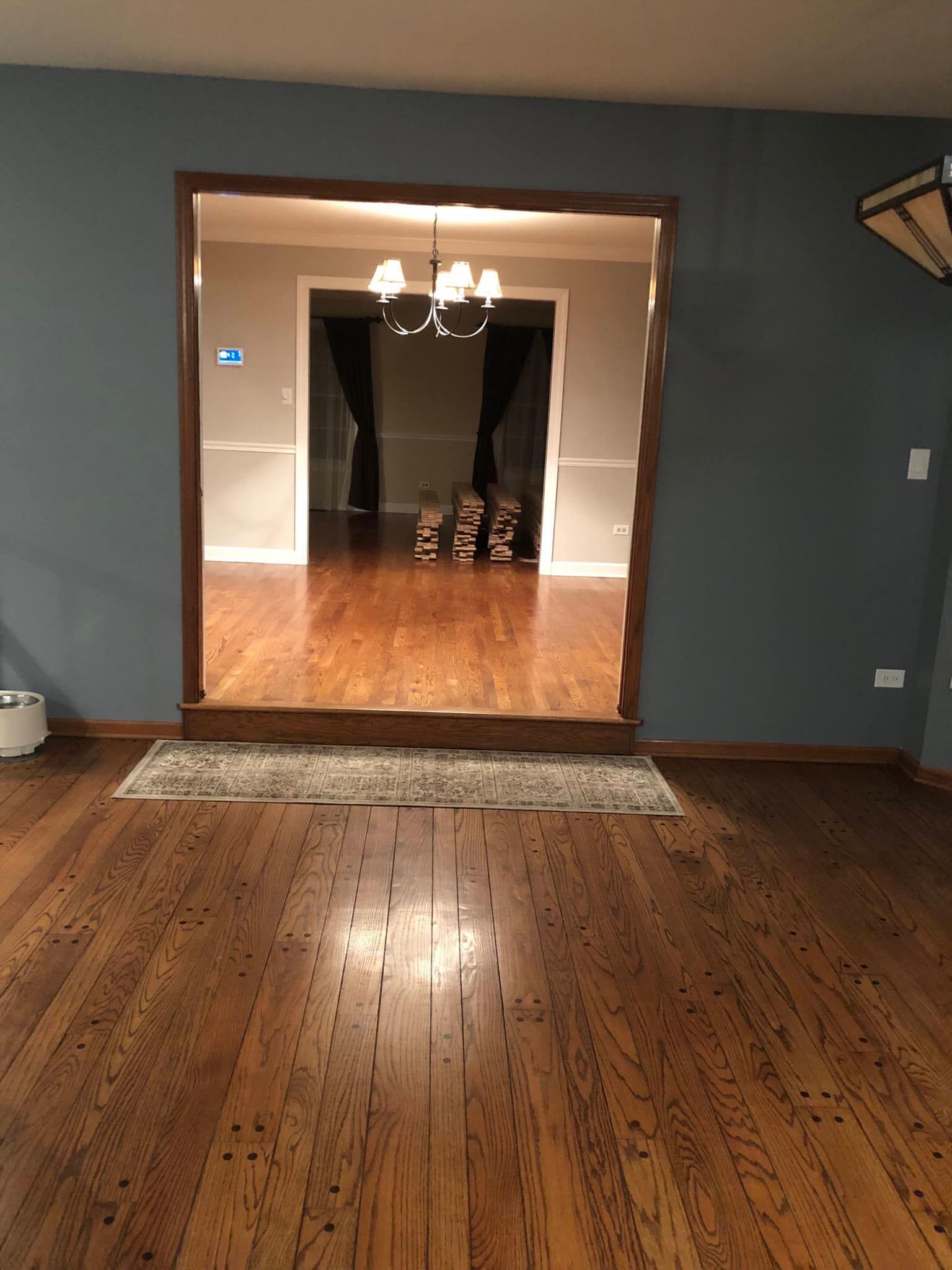 A living room with hardwood floors and blue walls.