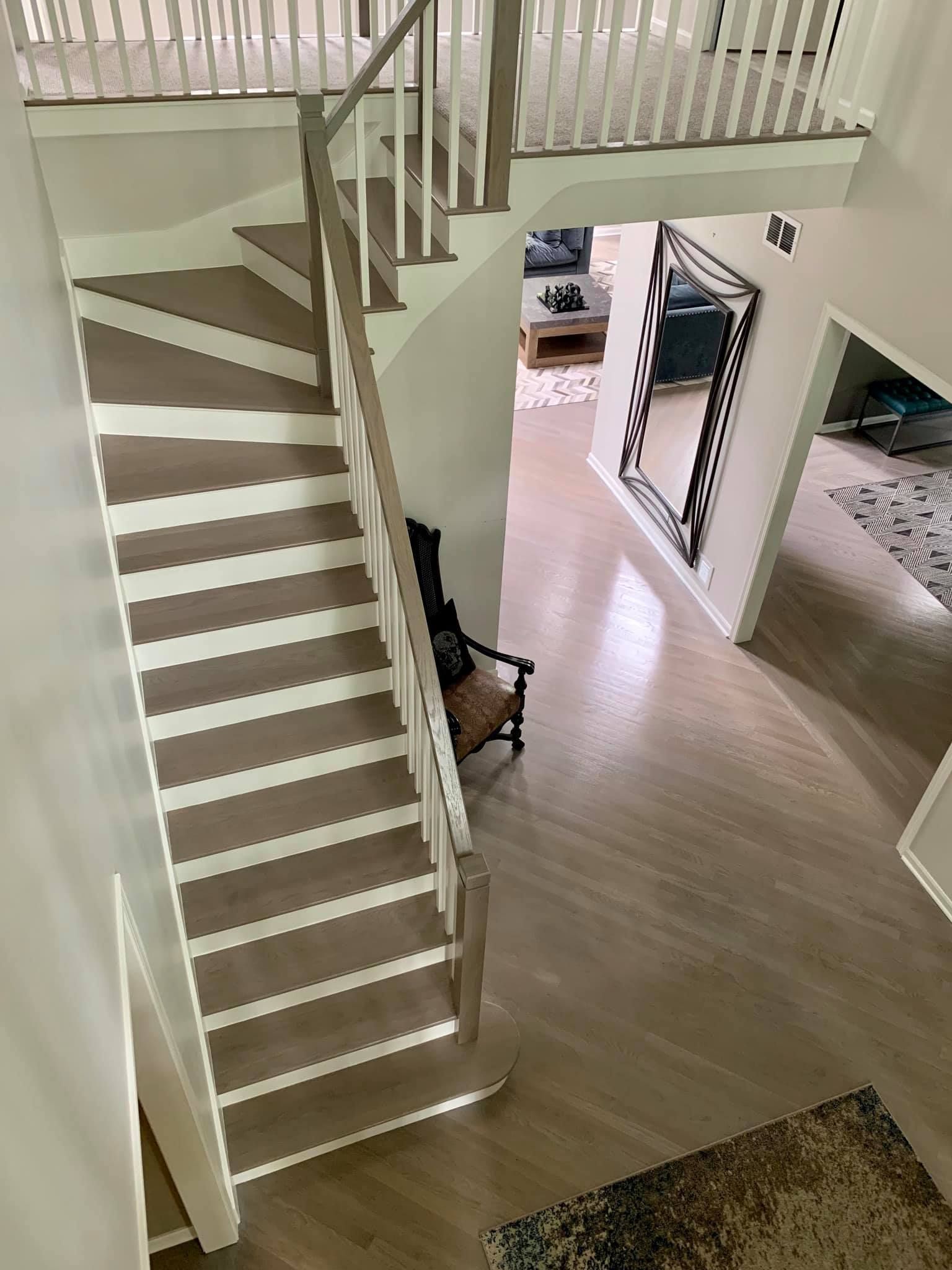 A view of a staircase from the second floor of a house.