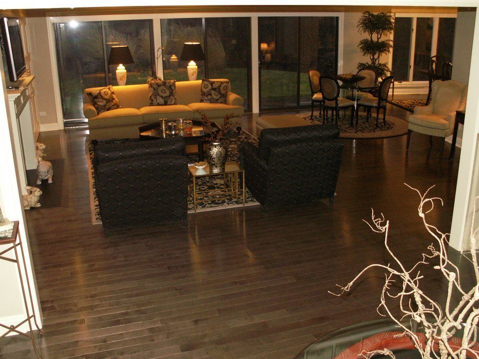 A living room with a couch and two chairs.