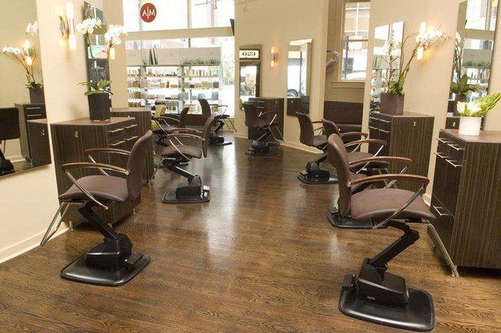A hair salon with a lot of chairs and mirrors.