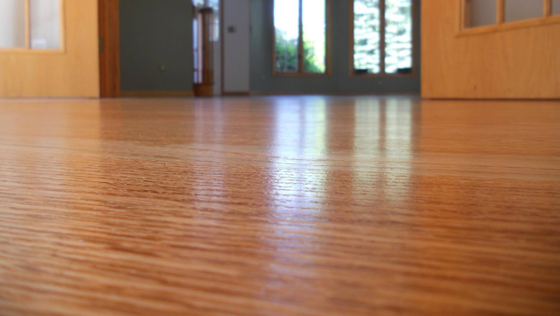 A close up of a wooden floor in an empty room.