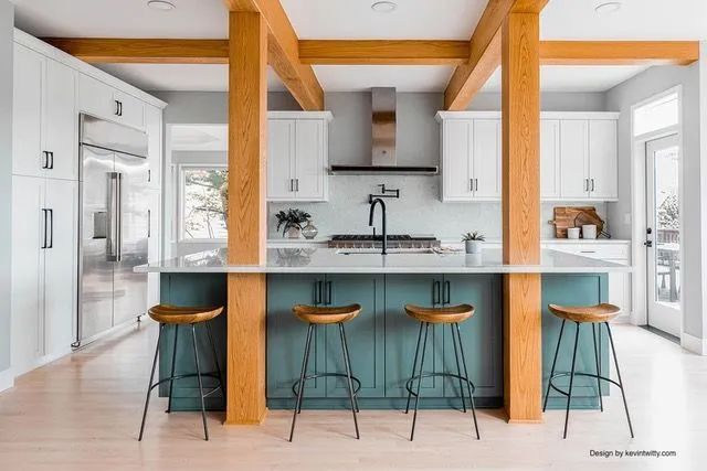 A kitchen with blue cabinets and wooden beams and stools.