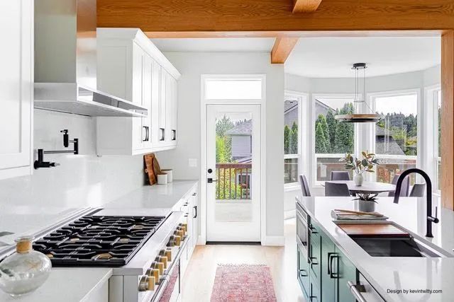 A kitchen with a stove top oven, sink, and cabinets.