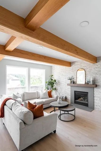 A living room with a white couch and a fireplace