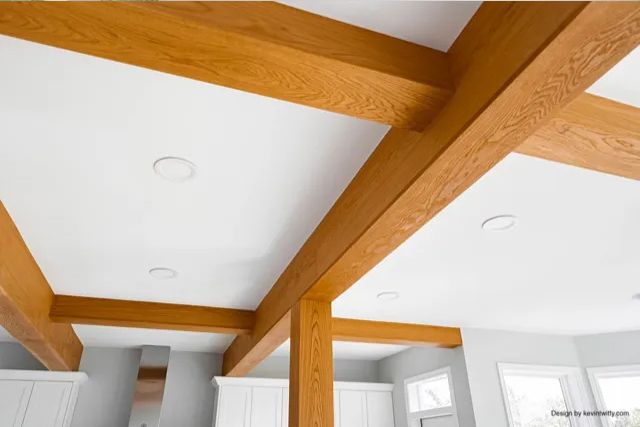 A kitchen with wooden beams and a white ceiling