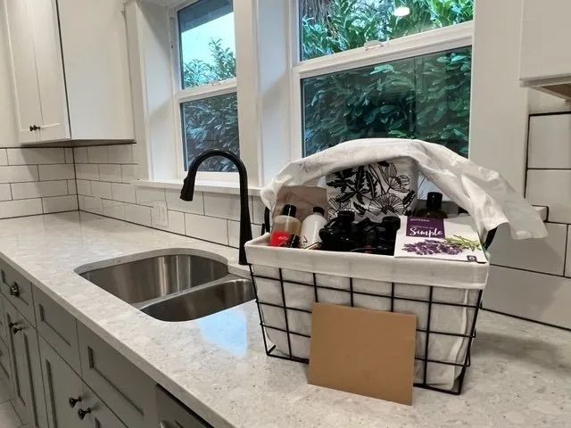 A kitchen with a sink and a basket on the counter.