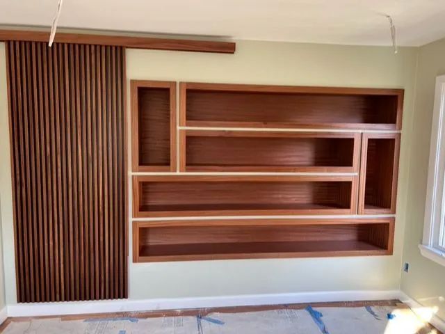 A room with a lot of shelves on the wall