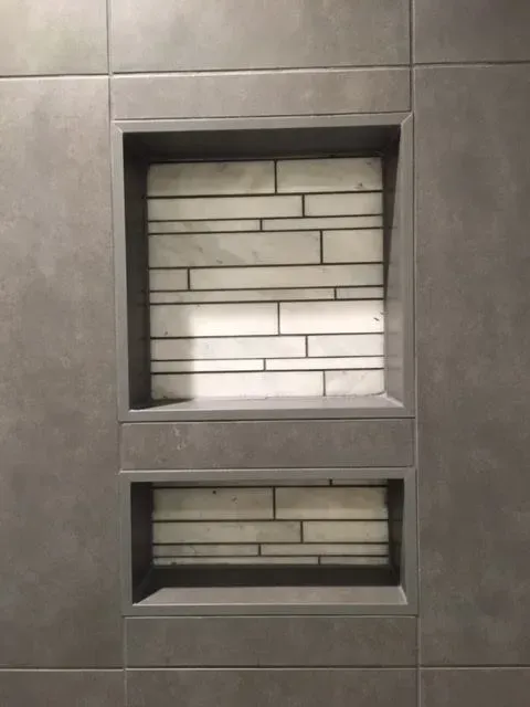 A close up of a shower niche in a bathroom.