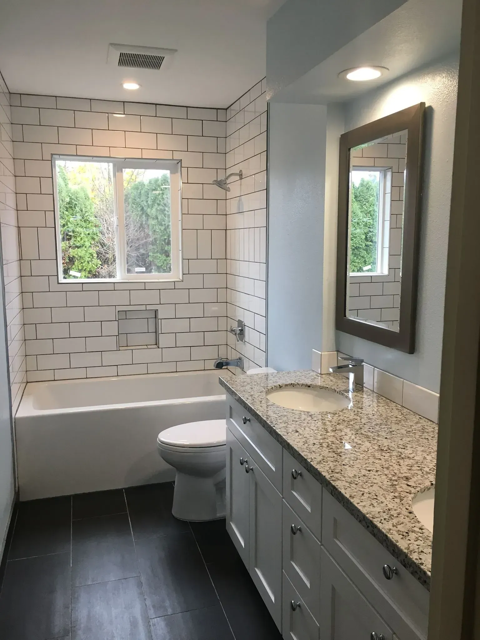 A bathroom with a toilet a sink and a window