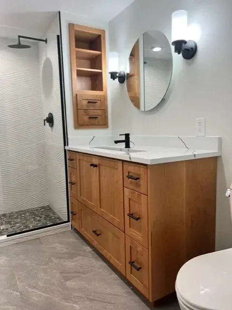 A bathroom with a sink , toilet and shower.