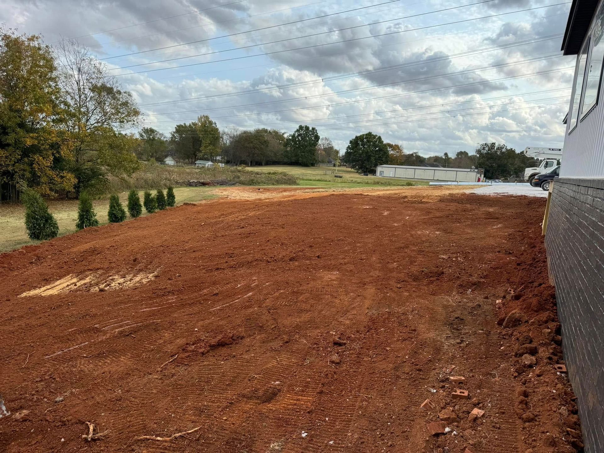 A large pile of dirt is sitting in front of a house.