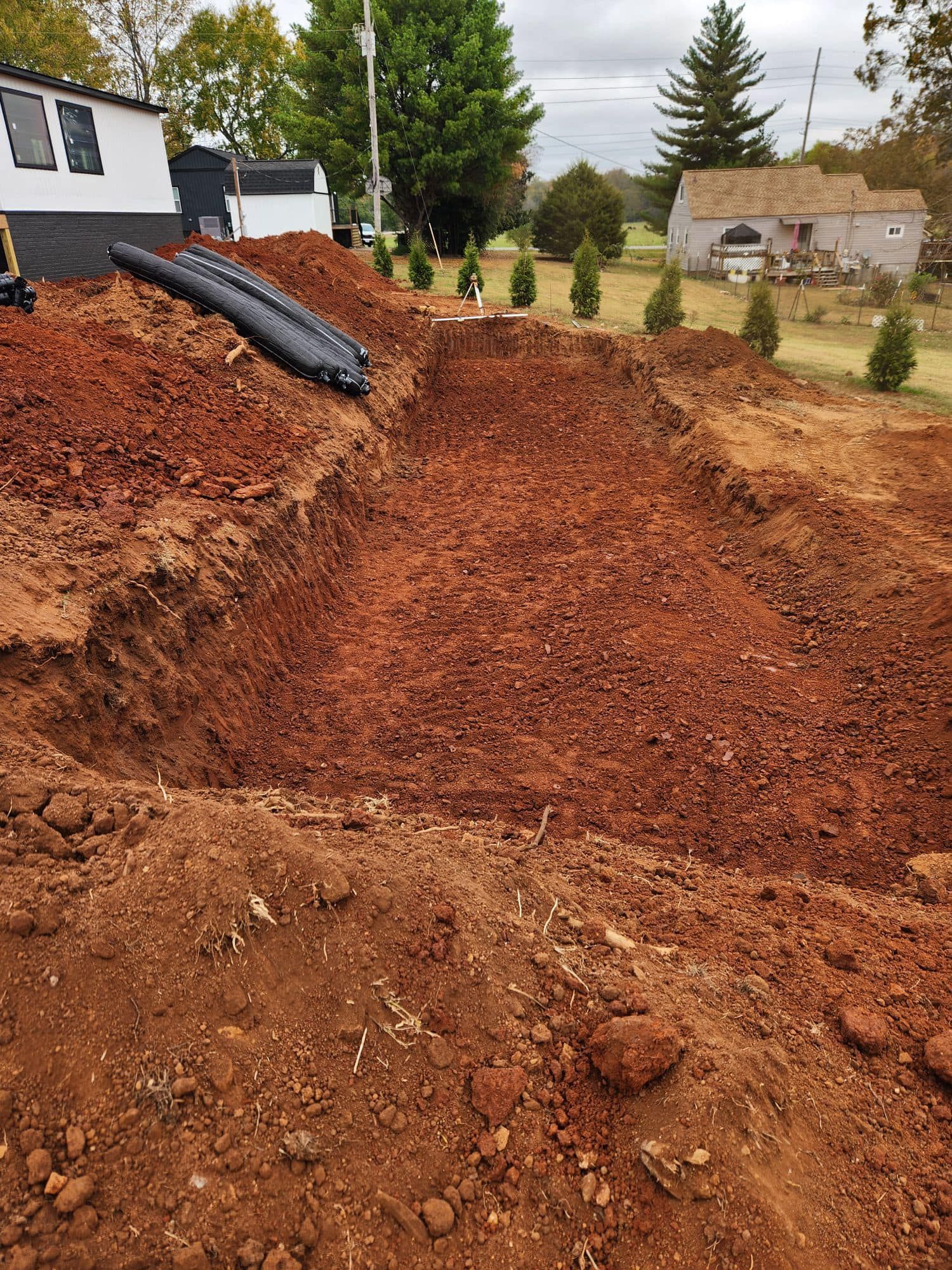 A large pile of dirt is sitting in front of a house.