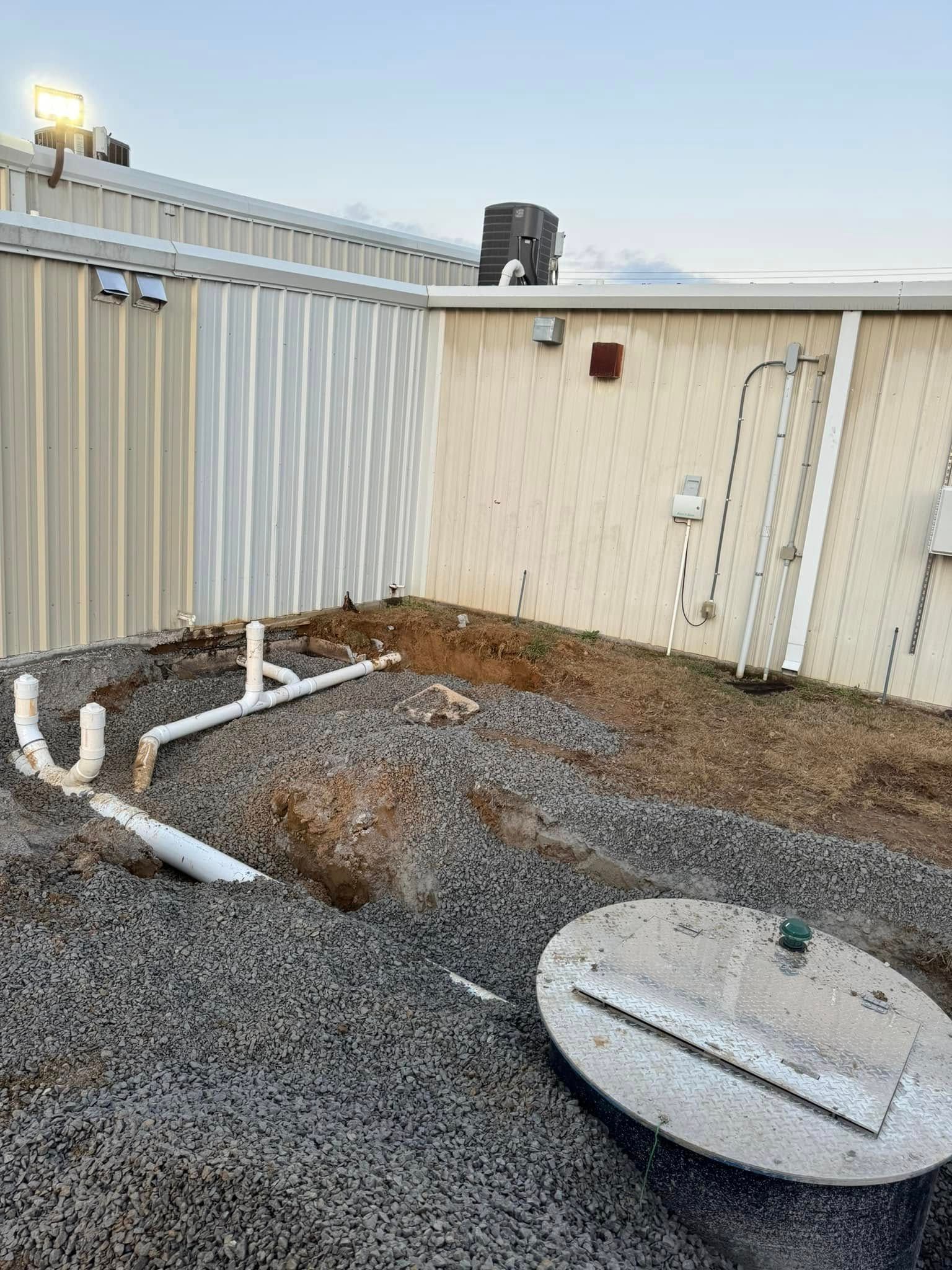 A septic tank is being installed in front of a building.