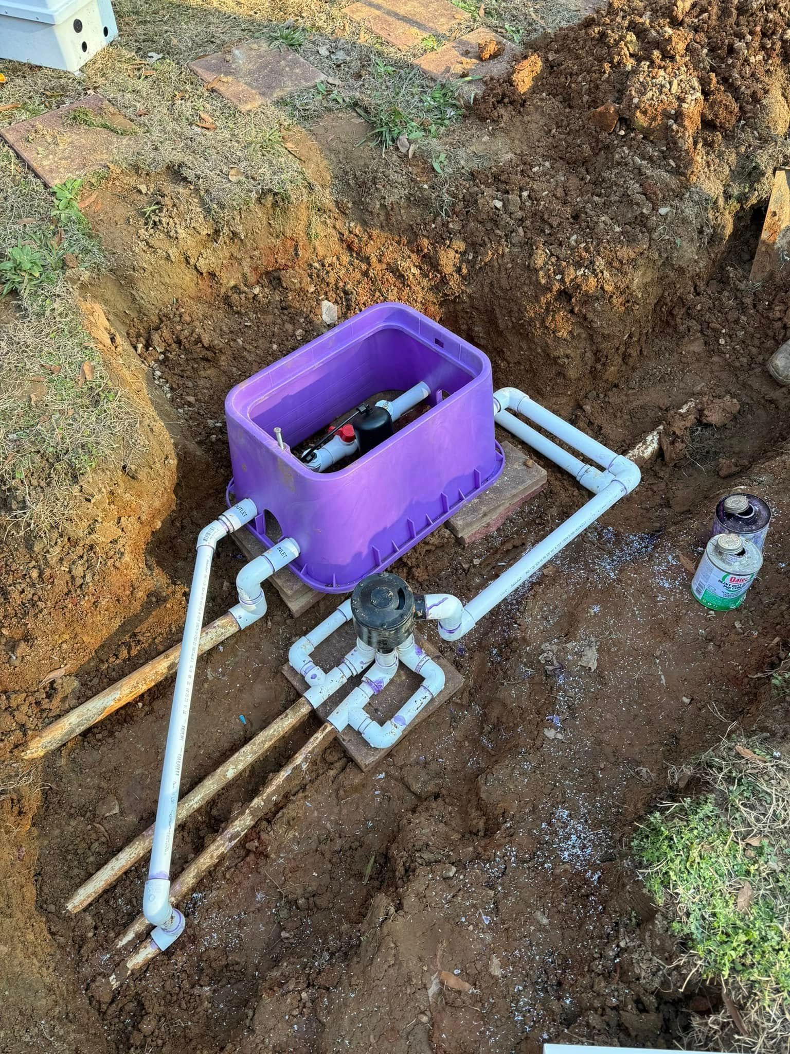 A purple box is sitting in the middle of a hole in the ground.