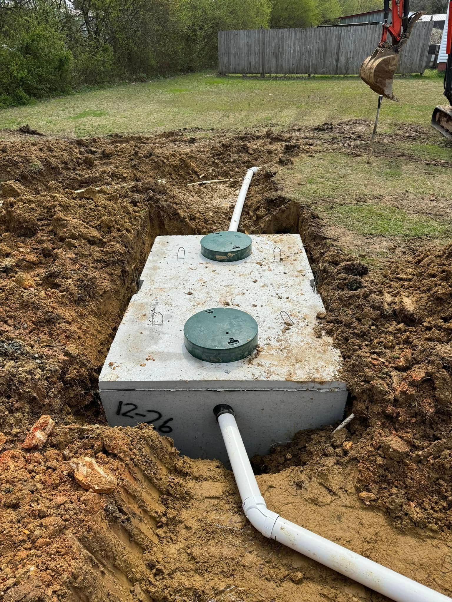 A septic tank is being installed in a hole in the ground.