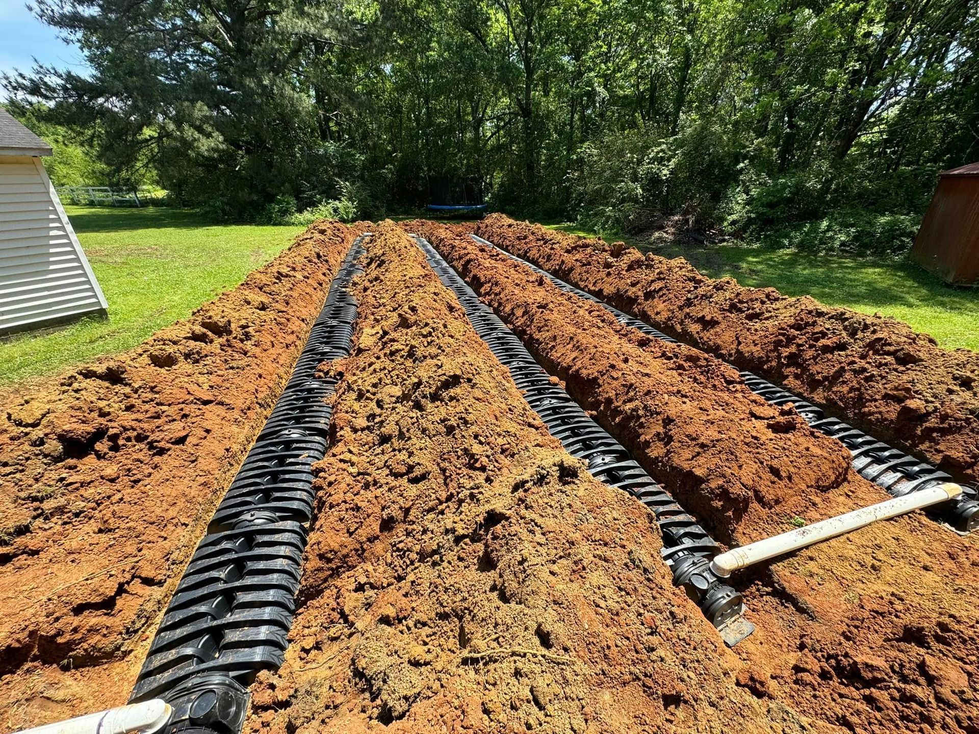 A septic system is being installed in a yard.