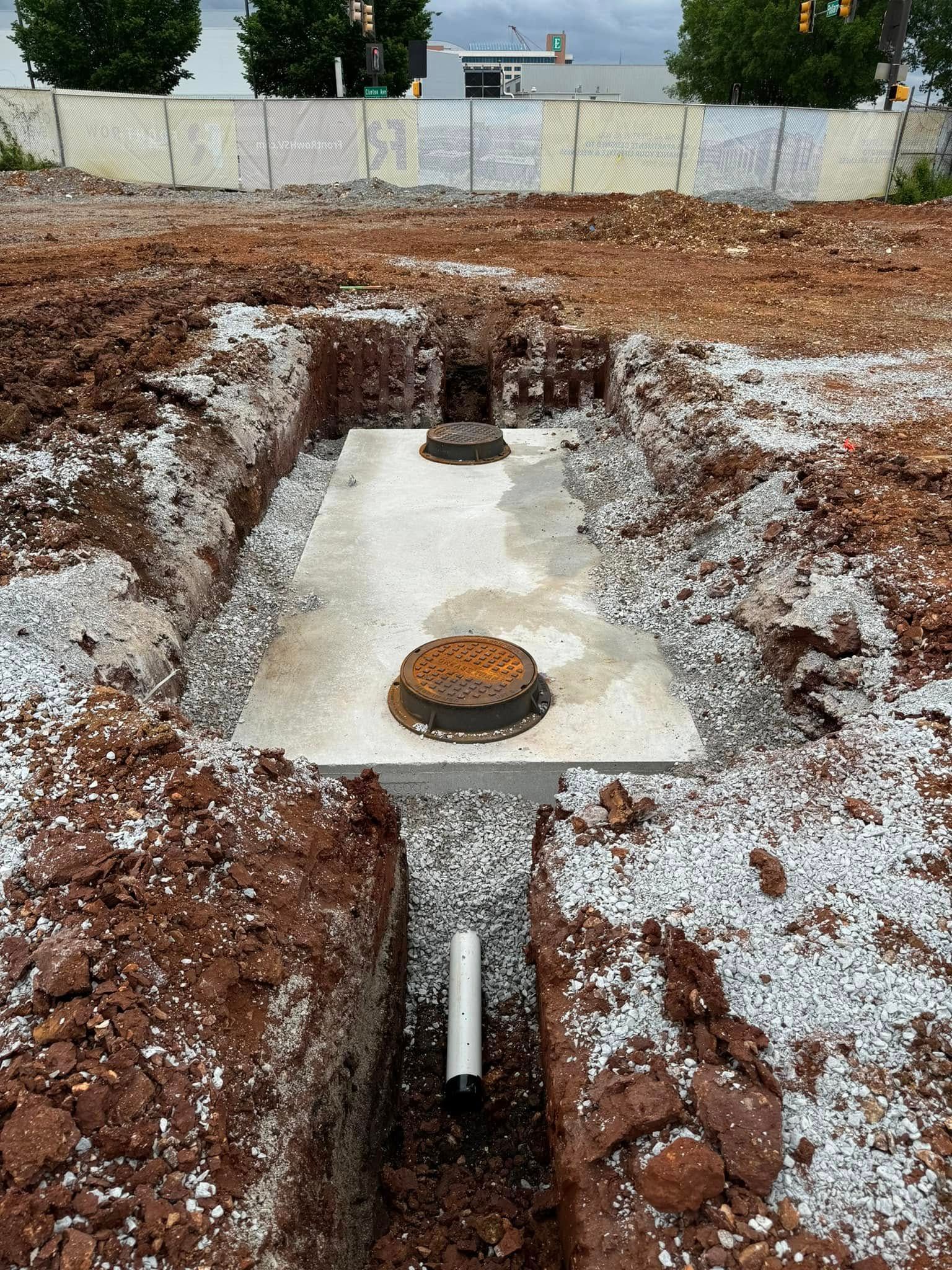A manhole cover is sitting in the middle of a hole in the ground.