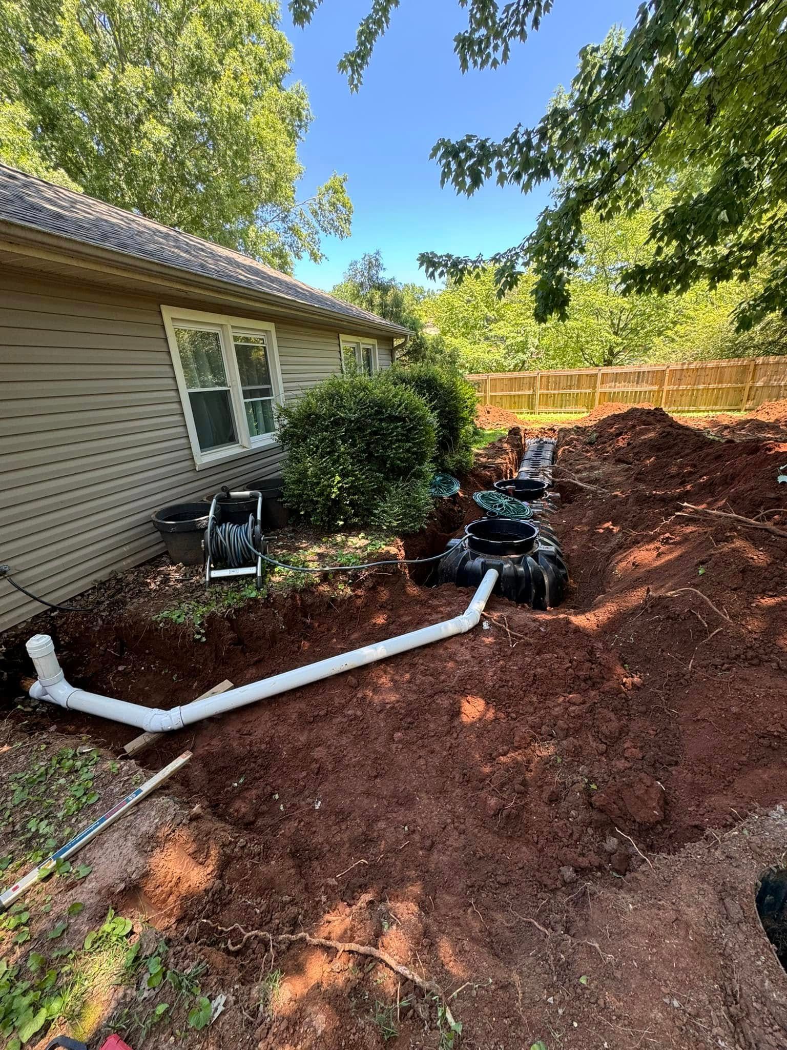 A large pile of dirt is in front of a house.