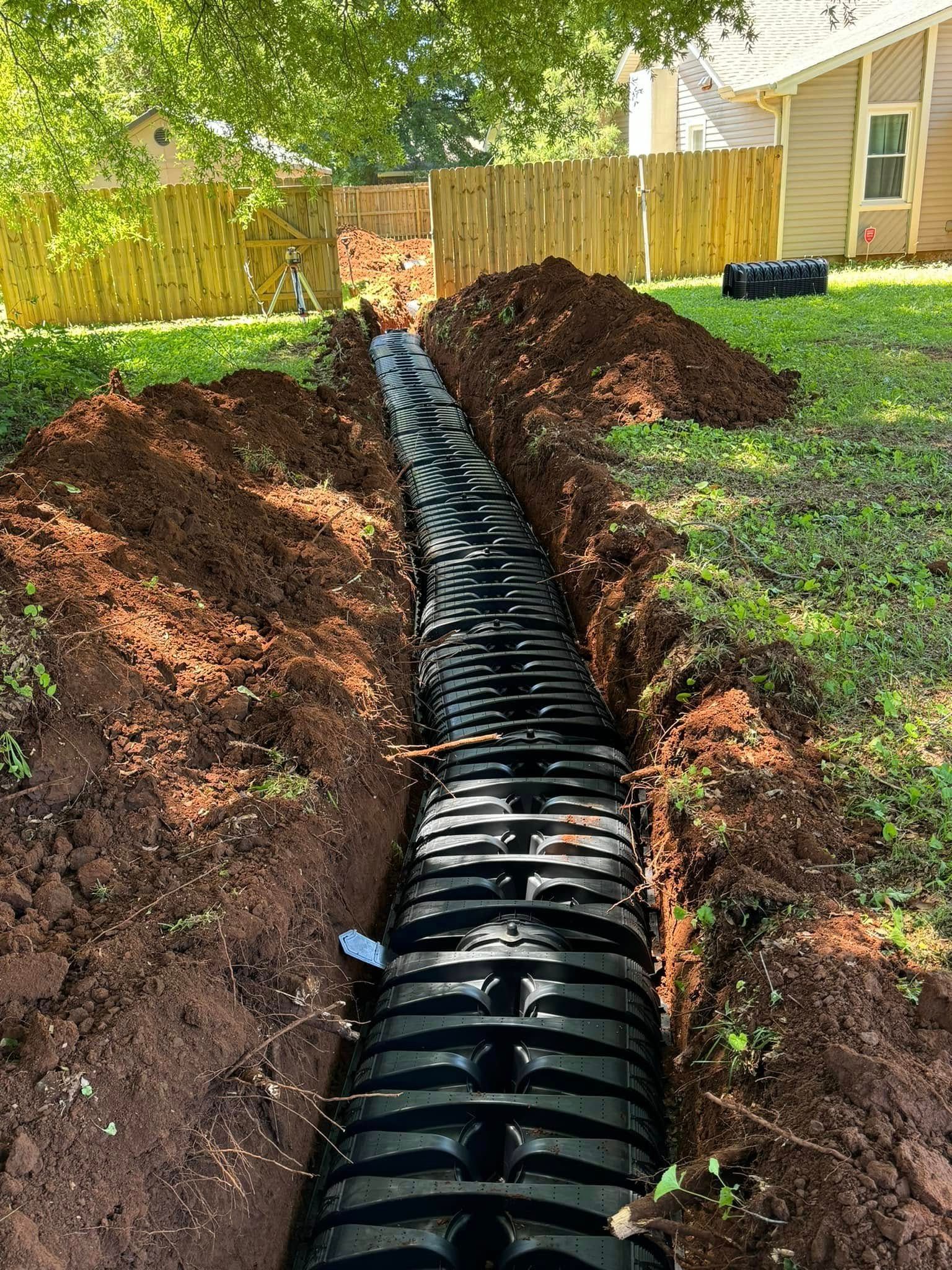 A septic tank is being installed in the backyard of a house.
